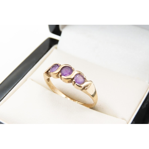 143 - Three Stone Amethyst Half Bezel Set Ring Mounted in 9 Carat Yellow Gold Ring Size N