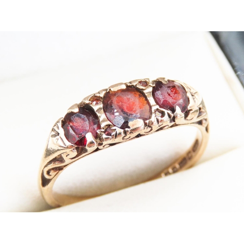 207 - Three Stone Red Garnet Set Ring Mounted in 9 Carat Yellow Gold Ring Size S