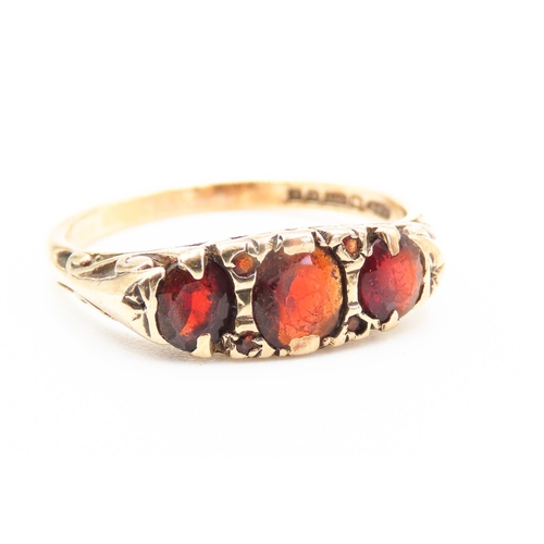 207 - Three Stone Red Garnet Set Ring Mounted in 9 Carat Yellow Gold Ring Size S