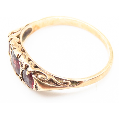 207 - Three Stone Red Garnet Set Ring Mounted in 9 Carat Yellow Gold Ring Size S