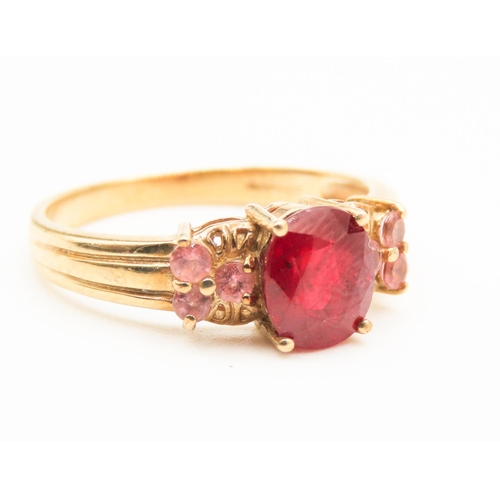 222 - Four Claw Set Ruby Centre Stone Ring Mounted in 9 Carat Yellow Gold Further Set Pink Garnet to Sides... 