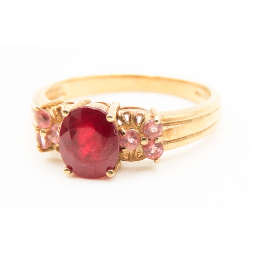 222 - Four Claw Set Ruby Centre Stone Ring Mounted in 9 Carat Yellow Gold Further Set Pink Garnet to Sides... 