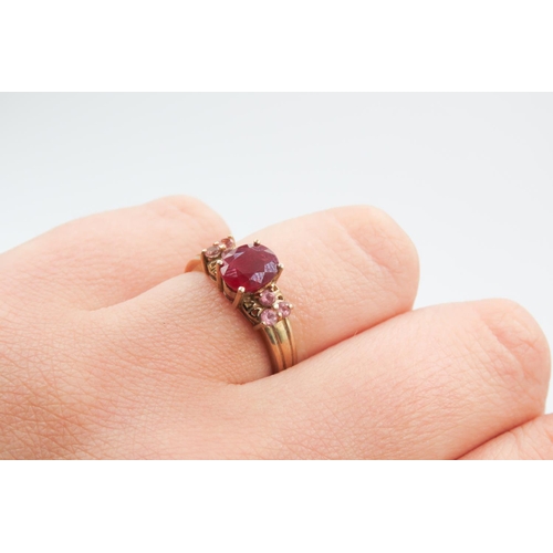 222 - Four Claw Set Ruby Centre Stone Ring Mounted in 9 Carat Yellow Gold Further Set Pink Garnet to Sides... 