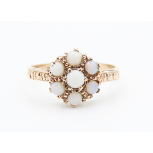 251 - Seven Stone Opal Set Daisy Form Ring Mounted in 9 Carat Yellow Gold Ring Size N