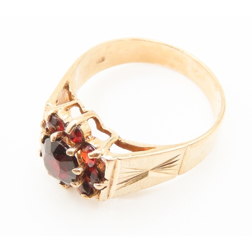 288 - Red Garnet Daisy Motif Ring Set in 9 carat Yellow Gold Ring Size N