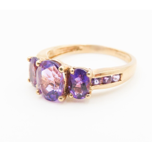 297 - Three Stone Oval Cut Amethyst set Ring Mounted in 9 Carat Yellow Gold Ring Size Q