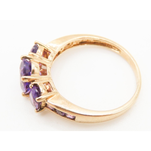 297 - Three Stone Oval Cut Amethyst set Ring Mounted in 9 Carat Yellow Gold Ring Size Q