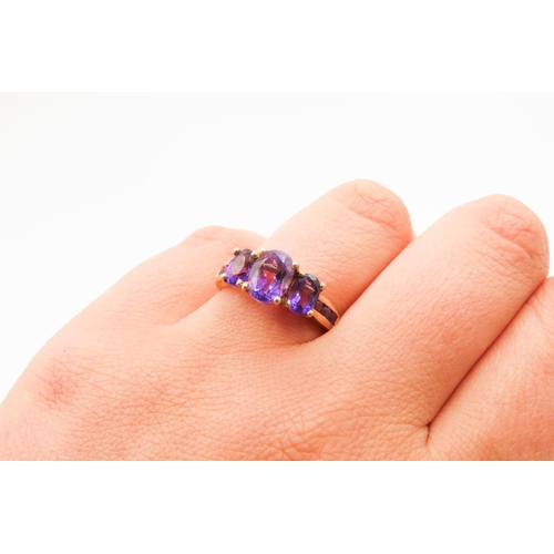 297 - Three Stone Oval Cut Amethyst set Ring Mounted in 9 Carat Yellow Gold Ring Size Q