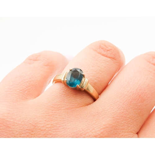 298 - Four Claw Set Blue Topaz Single Stone Ring Mounted in 9 Carat Yellow Gold Ring Size N