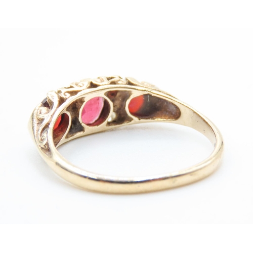 453 - Three Stone Red Garnet Ring Set in 9 Carat Yellow Gold with Further Garnet Decoration to Settings Ri... 