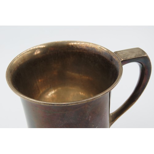 547 - Silver Cup With Shaped Handle above Turned Base Approximately 12cm High