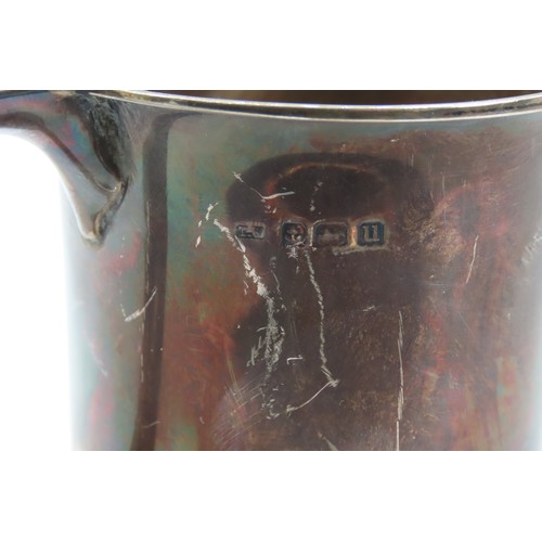 547 - Silver Cup With Shaped Handle above Turned Base Approximately 12cm High