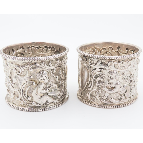 258 - Pair of Finely Detailed Silver Napkin Rings Playful Cherub Motifs to Each 4.5cm High 4cm Diameter