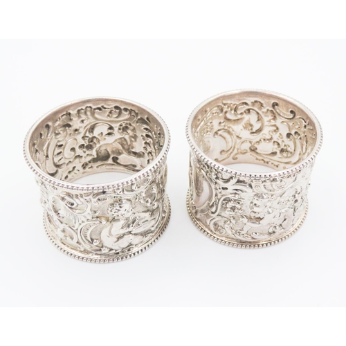 258 - Pair of Finely Detailed Silver Napkin Rings Playful Cherub Motifs to Each 4.5cm High 4cm Diameter