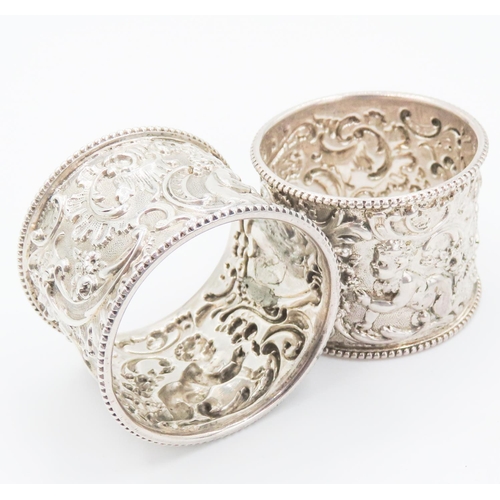 258 - Pair of Finely Detailed Silver Napkin Rings Playful Cherub Motifs to Each 4.5cm High 4cm Diameter