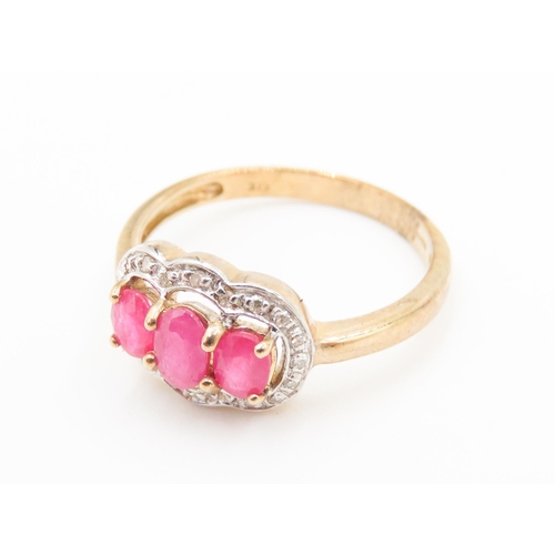 451 - Three Stone Ruby Set Ring Mounted in 9 Carat Yellow Gold Further Diamond Set Halo Surround Ring Size... 