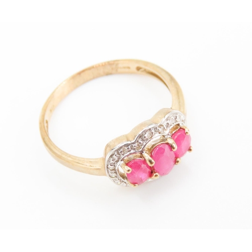 451 - Three Stone Ruby Set Ring Mounted in 9 Carat Yellow Gold Further Diamond Set Halo Surround Ring Size... 