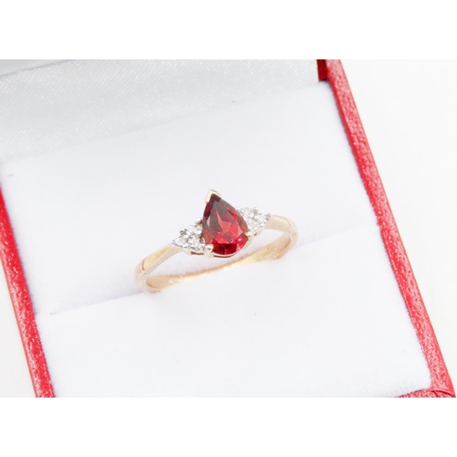 74 - Pear Cut Red Garnet Ring Mounted in 9 Carat Yellow Gold Further Diamonds Set to Shoulders Ring Size ... 