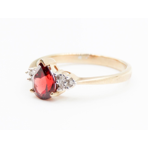 74 - Pear Cut Red Garnet Ring Mounted in 9 Carat Yellow Gold Further Diamonds Set to Shoulders Ring Size ... 