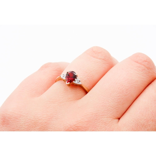 74 - Pear Cut Red Garnet Ring Mounted in 9 Carat Yellow Gold Further Diamonds Set to Shoulders Ring Size ... 