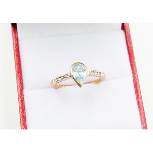 75 - Bezel Set Pear Cut Aquamarine Ring Mounted in 9 Carat Yellow Gold Further Diamonds Set to Shoulders ... 