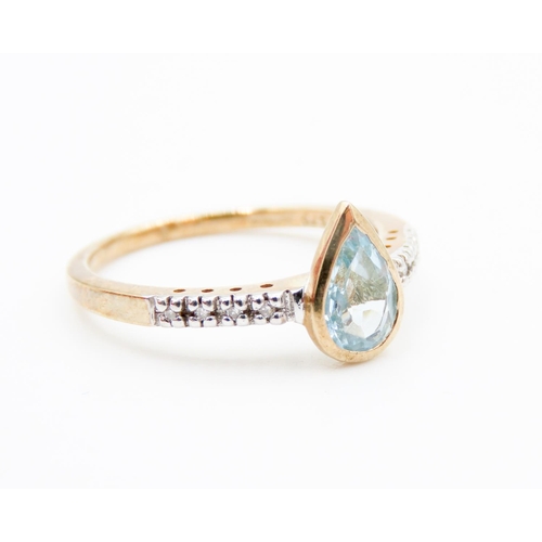 75 - Bezel Set Pear Cut Aquamarine Ring Mounted in 9 Carat Yellow Gold Further Diamonds Set to Shoulders ... 