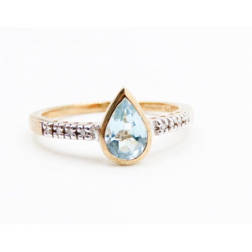 75 - Bezel Set Pear Cut Aquamarine Ring Mounted in 9 Carat Yellow Gold Further Diamonds Set to Shoulders ... 