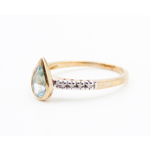 75 - Bezel Set Pear Cut Aquamarine Ring Mounted in 9 Carat Yellow Gold Further Diamonds Set to Shoulders ... 