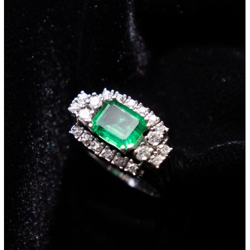 101 - Emerald Ring with Diamond Cluster Set Surround Mounted in 18 Carat White Gold Ring Size O