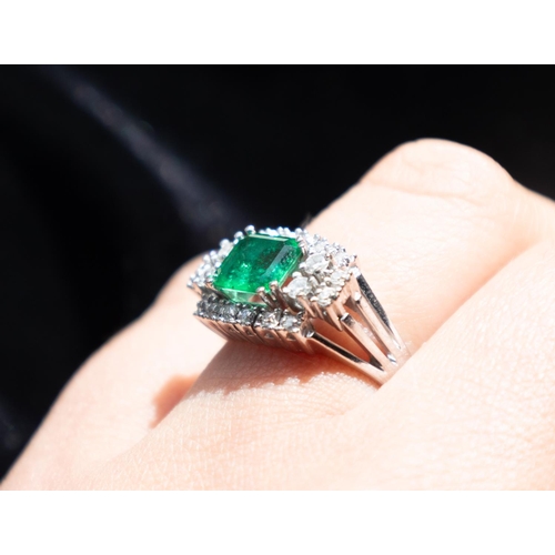 101 - Emerald Ring with Diamond Cluster Set Surround Mounted in 18 Carat White Gold Ring Size O