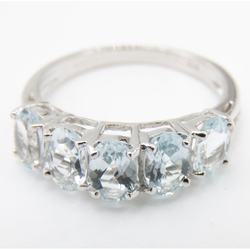 12 - Oval Cut Aquamarine Five Stone Ring Mounted in 9 Carat White Gold Ring Size M