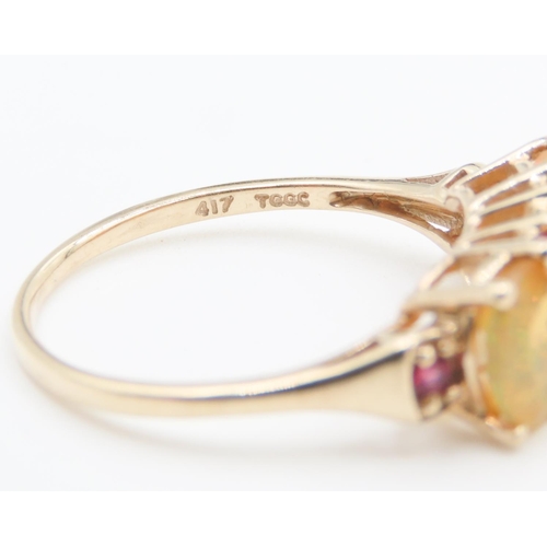 166 - Three Stone Opal Ring with further Ruby Insets Mounted in 10 Carat Yellow Gold Ring Size P