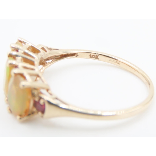 166 - Three Stone Opal Ring with further Ruby Insets Mounted in 10 Carat Yellow Gold Ring Size P