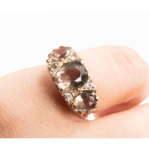 17 - Attractively Detailed Smoky Quartz Set Three Stone Ring Mounted in 9 Carat Yellow Gold Ring Size M