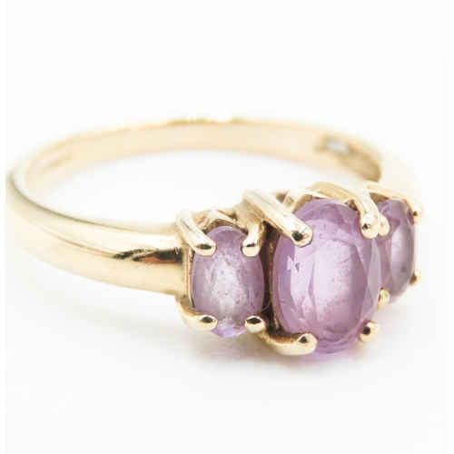 173 - Amethyst Three Stone Basket Set Ring Mounted in 9 Carat Yellow Gold Ring Size M and a Half