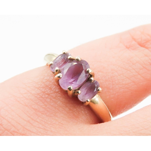 173 - Amethyst Three Stone Basket Set Ring Mounted in 9 Carat Yellow Gold Ring Size M and a Half