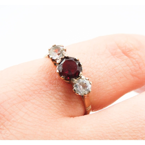 183 - Three Stone Red Garnet and Gemstone Set Ladies Ring Mounted in 9 Carat Yellow Gold Ring Size K