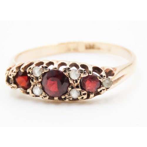 189 - Red Garnet Three Stone Ring Mounted in 9 Carat Yellow Gold Ring Size P