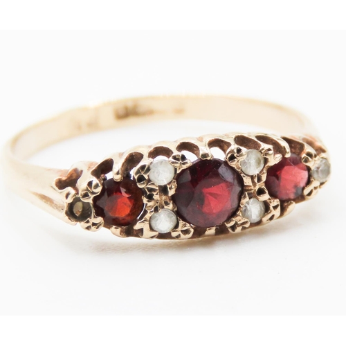 189 - Red Garnet Three Stone Ring Mounted in 9 Carat Yellow Gold Ring Size P