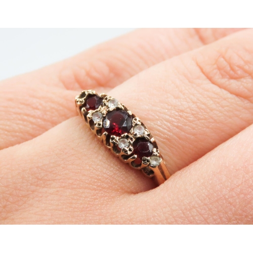 189 - Red Garnet Three Stone Ring Mounted in 9 Carat Yellow Gold Ring Size P