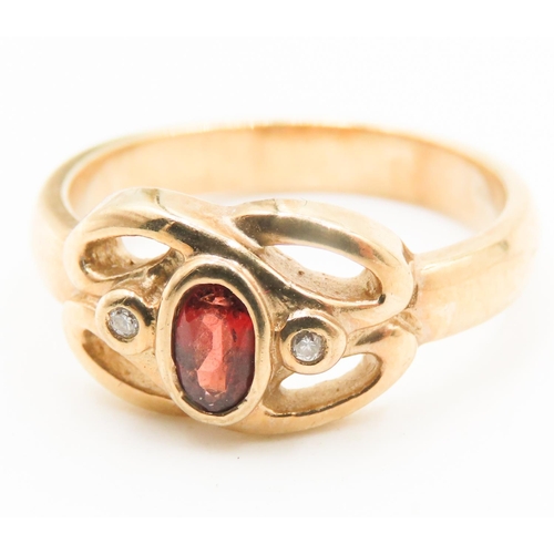 198 - Bezel Set Red Garnet and Diamond Set Knot Form Ring Mounted in 9 Carat Yellow Gold Ring Size M