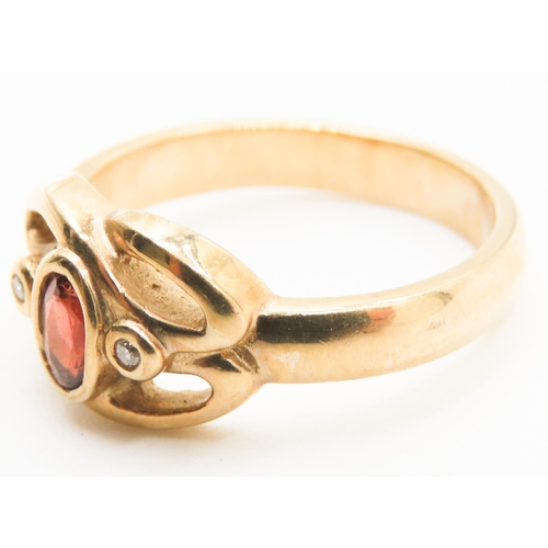 198 - Bezel Set Red Garnet and Diamond Set Knot Form Ring Mounted in 9 Carat Yellow Gold Ring Size M