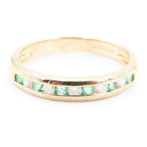 221 - Emerald and Diamond Channel Set Half Eternity Ring Mounted in 9 Carat Yellow Gold Ring Size N