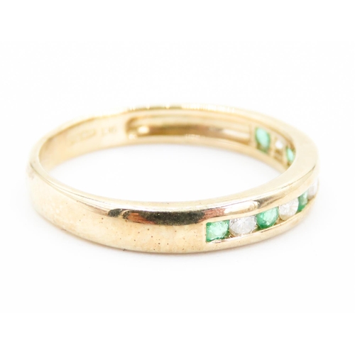 221 - Emerald and Diamond Channel Set Half Eternity Ring Mounted in 9 Carat Yellow Gold Ring Size N