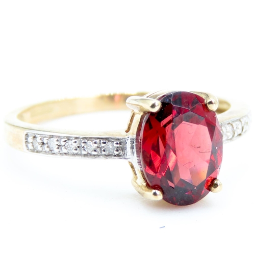 228 - Oval Cut Red Garnet Centre Stone Ring Mounted in 9 Carat Yellow Gold Further Diamonds Set to Shoulde... 