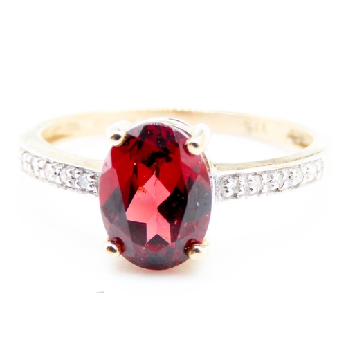 228 - Oval Cut Red Garnet Centre Stone Ring Mounted in 9 Carat Yellow Gold Further Diamonds Set to Shoulde... 