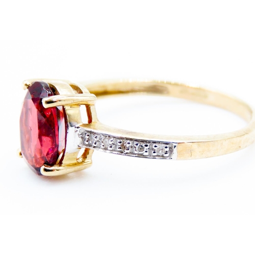 228 - Oval Cut Red Garnet Centre Stone Ring Mounted in 9 Carat Yellow Gold Further Diamonds Set to Shoulde... 