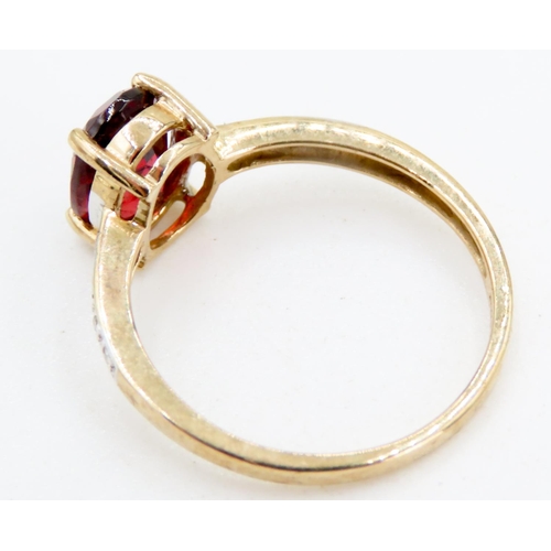 228 - Oval Cut Red Garnet Centre Stone Ring Mounted in 9 Carat Yellow Gold Further Diamonds Set to Shoulde... 