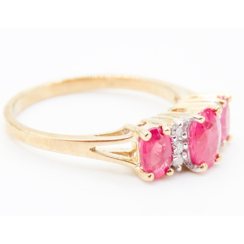 237 - Ruby Three Stone and Diamond Set Ring Mounted in 9 Carat Yellow Gold Ring Size M