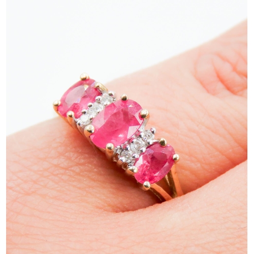 237 - Ruby Three Stone and Diamond Set Ring Mounted in 9 Carat Yellow Gold Ring Size M